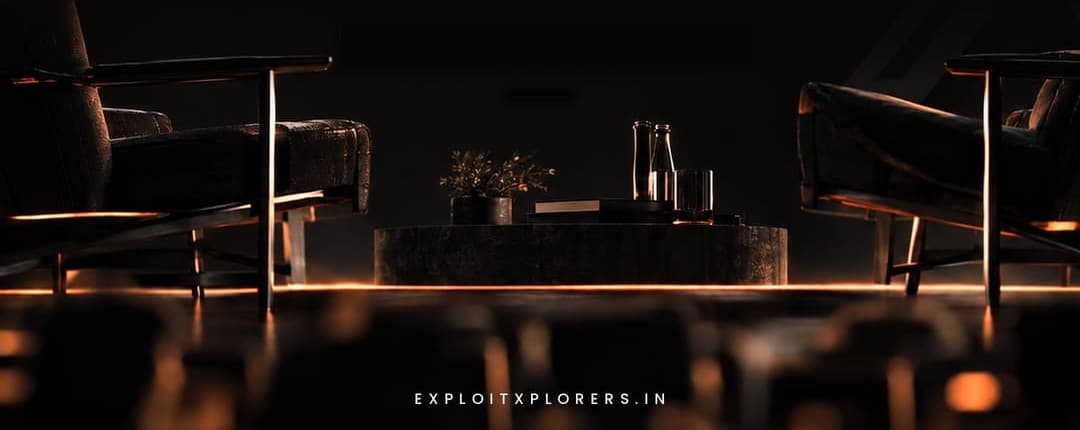 Two armchairs facing each other across a low table in a dimly lit room, lit by a copper glow